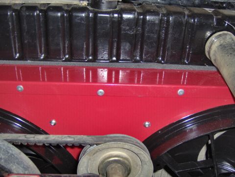 1978 Ford Bronco - Close-up view of dual electric fans mounted behind a red shroud in front of a vehicle's radiator.