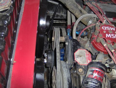 1978 Ford Bronco - Close-up of an engine bay showing dual electric fans, MSD ignition, and various hoses and belts.