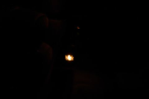 1996 Mercury Grand Marquis - A close-up view of an illuminated door handle with a yellow glow.