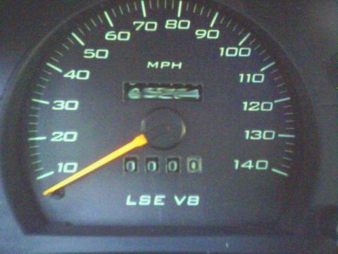 1996 Mercury Grand Marquis - Close-up of a vehicle's dashboard gauge cluster, displaying speed and mileage.