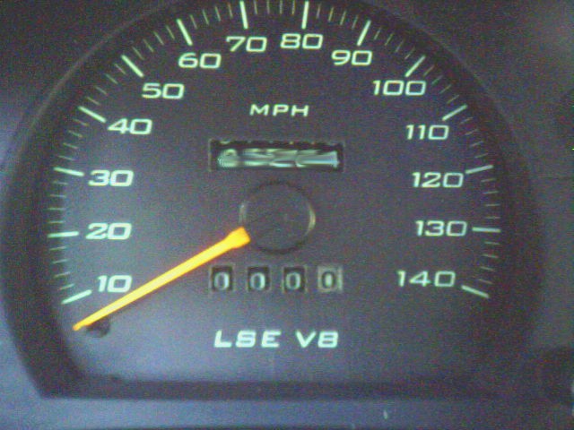 Green-lit speedometer gauge marked MPH to 140 with 'LSE V8' text and 0000 odometer