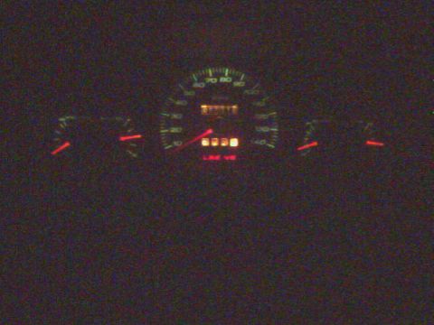 1996 Mercury Grand Marquis - Illuminated car dashboard gauges, including speedometer and odometer, are visible in the dark.