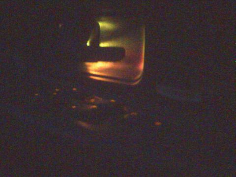 1996 Mercury Grand Marquis - A close-up of a car's illuminated door handle, with small orange lights visible on the floor below.