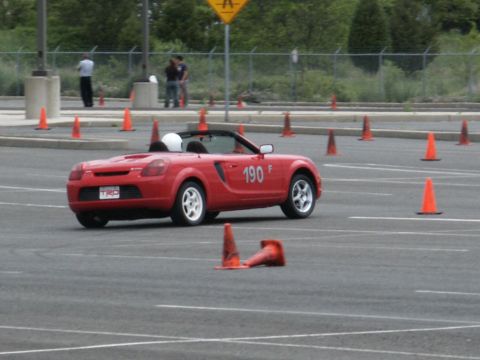 2001 Mercury Grand Marquis - Red convertible sports car with number 190 on door navigates a cone course.