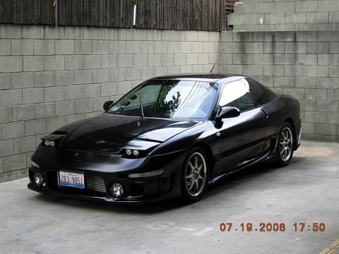 1993 Ford Probe - Black 1993 Ford Probe coupe with aftermarket wheels and body kit parked in front of a brick wall.
