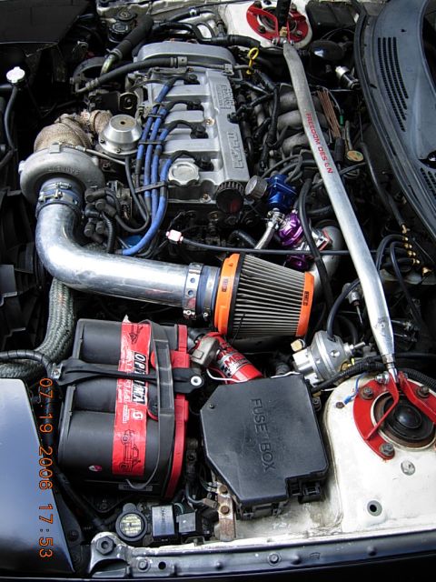 1993 Ford Probe - Close-up of a modified engine bay a turbocharger and custom intake system.