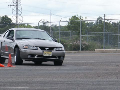 2001 Mercury Grand Marquis - Gray Ford Mustang with a New Jersey license plate SMT-19J parked on asphalt near orange cones.
