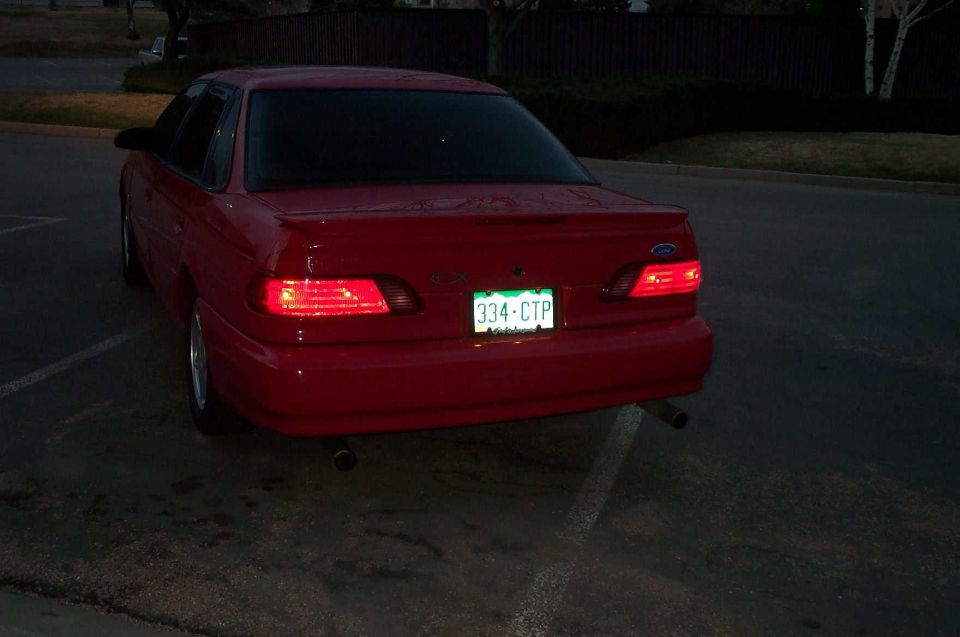 Red 1995 Ford Taurus sedan, rear view, license plate 334-CTP