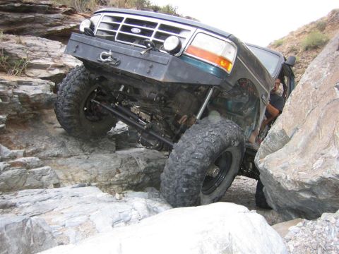 1994 Ford Bronco - This modified Ford Bronco is shown attempting to traverse a difficult rocky terrain.