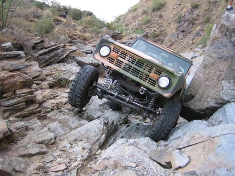 1994 Ford Bronco - This Ford Bronco is shown off-roading on a steep, rocky incline.