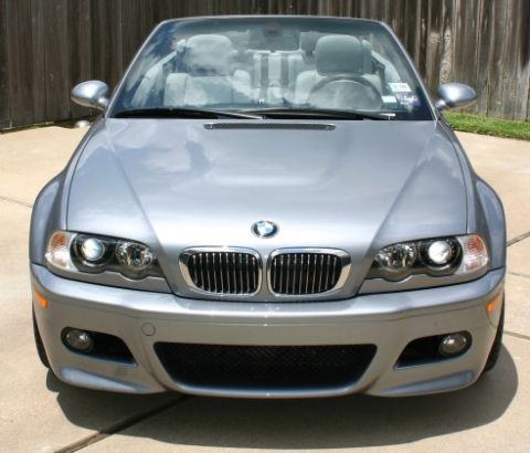 1988 Ford Crown Victoria LTD - Silver BMW M3 convertible with a light gray interior is parked in front of a wooden fence.