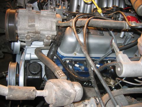 1992 Ford Bronco - Close-up of a V8 engine bay showing a silver aluminum A/C compressor with ribbed pulleys on the left, blue-painted valve covers, an MSD-lab…