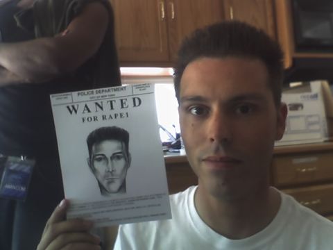 1995 Ford Probe - A man holds up a police department wanted poster a sketch of a suspect.