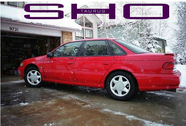 Red Ford Taurus SHO sedan in profile on a snowy driveway with SHO text overlay