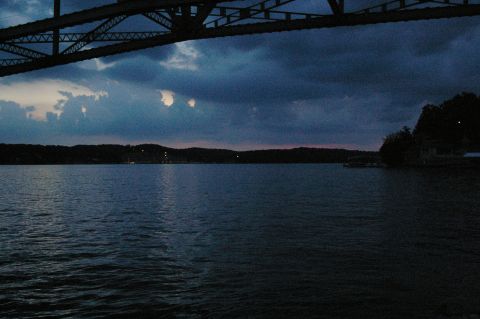1998 Jeep TJ - View of a lake and bridge structure under a cloudy sky at dusk.
