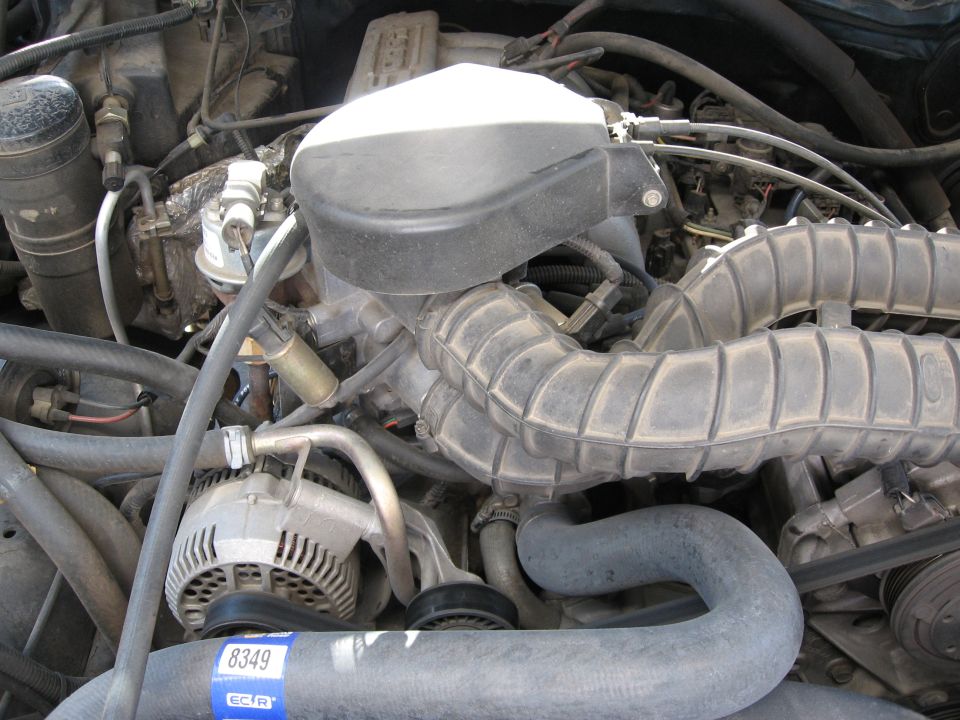 1994 Ford Bronco engine bay with alternator and air intake hoses