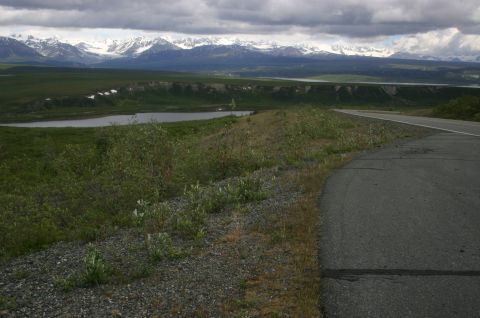 2003 Jeep TJ - A scenic view of a road winding through a vast landscape with mountains in the distance.