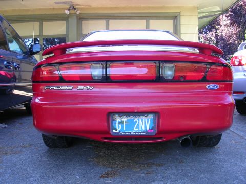 1996 Ford Probe - Rear view of a red Ford Probe with a spoiler and dual exhaust pipes.