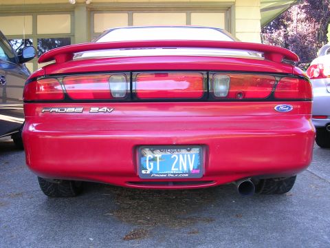 1996 Ford Probe - Rear view of a red 1996 Ford Probe, its distinctive taillights, spoiler, and 'PROBE 24V' badging.