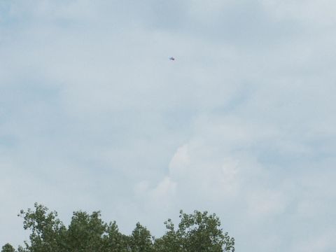 2001 Mercury Grand Marquis - A small aircraft is visible in the sky above trees, with a "SUPERMOTORS" watermark at the bottom right.