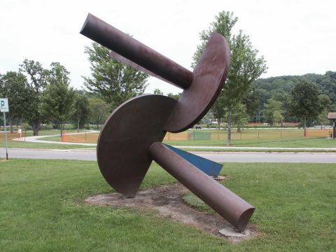 2001 Mercury Grand Marquis - An abstract metal sculpture is displayed in a park, with trees and a road visible in the background.