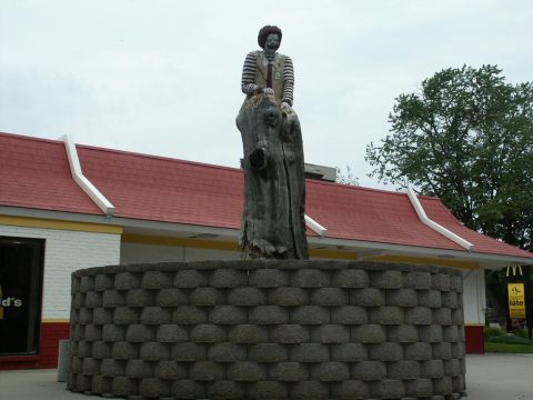 2001 Mercury Grand Marquis - A statue of Ronald McDonald sits atop a tree stump in front of a McDonald's restaurant.