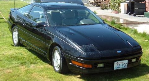 1991 Ford Probe - This 1991 Ford Probe GT Turbo features a distinctive coupe body style and pop-up headlights, seen here parked on a grassy lawn.