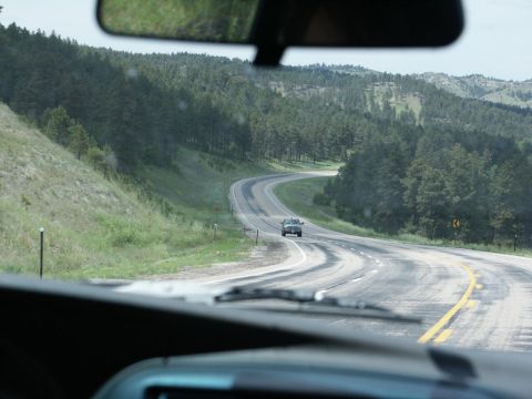 2001 Mercury Grand Marquis - Driving on a scenic, winding road through a forested, hilly area.