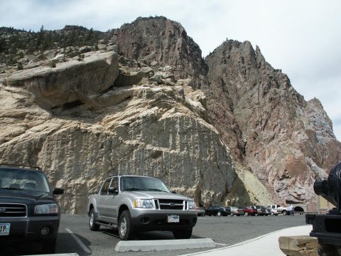 2001 Mercury Grand Marquis - A silver Ford Explorer Sport Trac is parked in a lot with a large rock formation in the background.