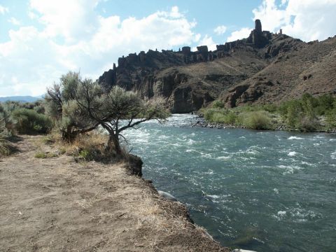 2001 Mercury Grand Marquis - A wide river rushes through a canyon under a partly cloudy sky.