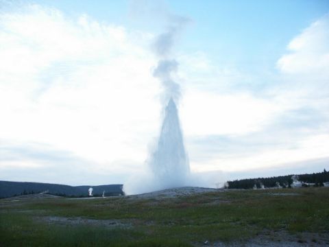 2001 Mercury Grand Marquis - Old Faithful geyser erupts, sending a massive plume of water and steam skyward.