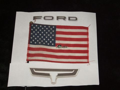 1972 Ford Ranchero - A display Ford emblems and an American flag.