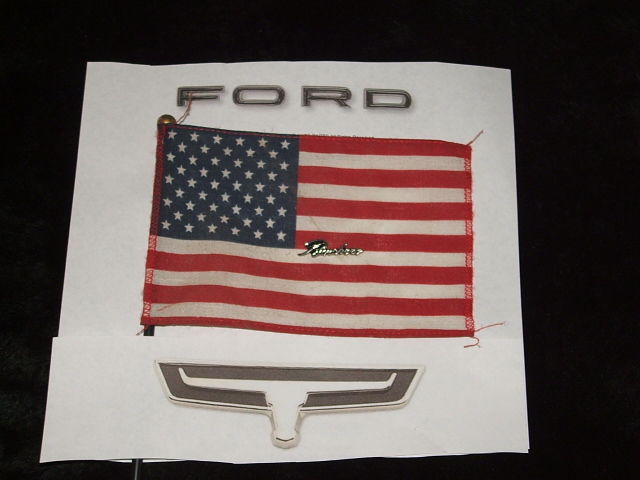 Ford nameplate, American flag, and a Ford emblem