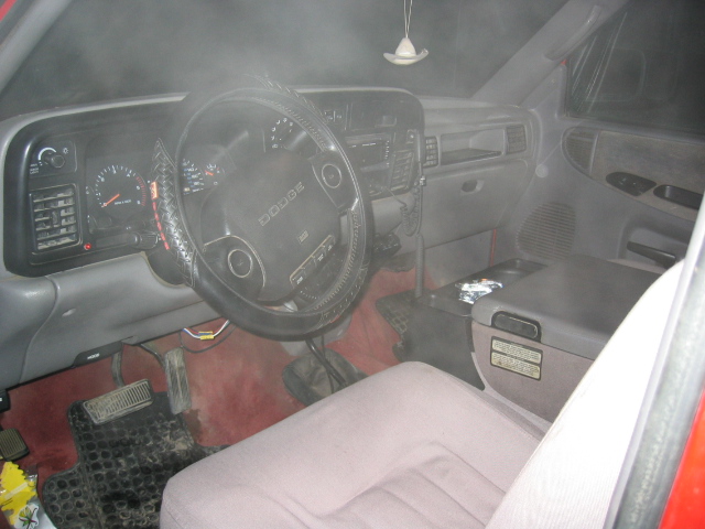 Gray Dodge pickup interior with airbag steering wheel, gauges and cloth bench seat