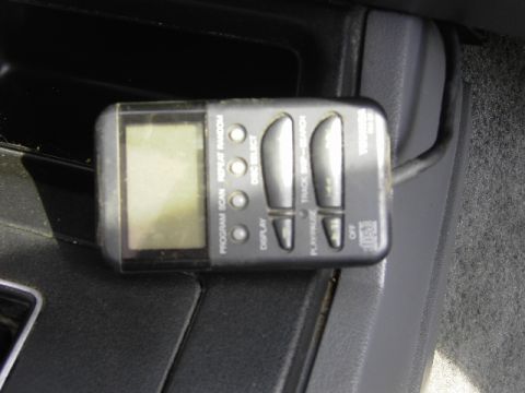 1995 Jeep YJ - A portable CD player is mounted in the vehicle's interior, showing various playback control buttons.