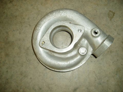 1996 Ford Probe - A close-up view of an aluminum turbocharger housing with cast-in text.