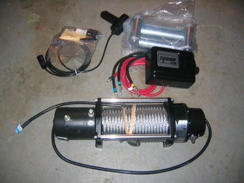 1979 Ford Bronco - New Tabor 12K winch and accessories laid out on a concrete floor.