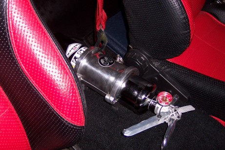 1972 Ford Ranchero - A fire extinguisher is mounted between the seats of a vehicle.