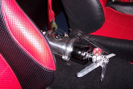 1972 Ford Ranchero - A fire extinguisher is secured between the seats of a vehicle.