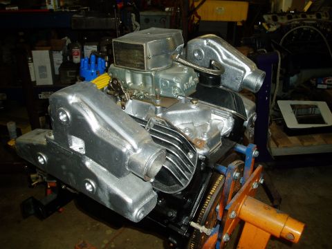1978 Ford F-250 - A V8 engine is mounted on an engine stand, custom chrome components and a large carburetor.