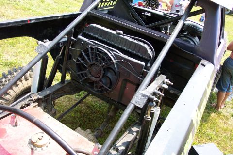 1978 Ford Bronco - The interior of a modified off-road vehicle shows its exposed radiator and fan assembly.