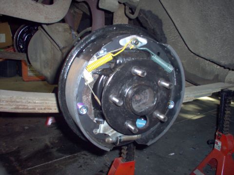 1970 Ford Ranchero - Close-up of a vehicle's rear drum brake assembly, showing new brake shoes and springs.