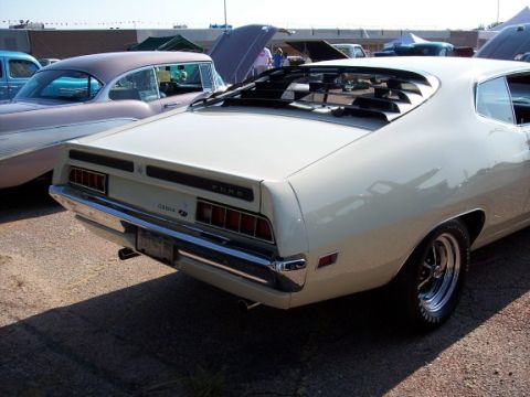 1972 Ford Ranchero - The rear of a 1970 Ford Torino GT is visible, its distinctive taillights and chrome bumper.