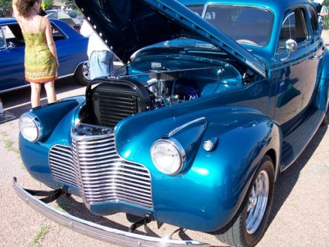 1972 Ford Ranchero - A classic blue sedan is displayed with its hood up, revealing the engine compartment.