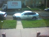 1993 Ford Probe - A white coupe is parked on the street, with a delivery truck visible in the background.