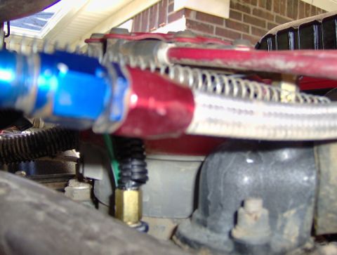 1978 Ford Bronco - Close-up view of engine bay components, including braided hoses and fittings.
