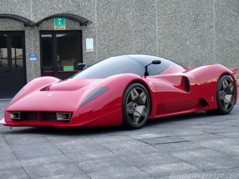 1991 Ford Probe - A red mid-engine concept-style supercar with a low, curved body, large glass canopy, and five-spoke wheels, photographed from a front three…