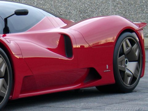1991 Ford Probe - Tight low side shot of a red mid-engine concept supercar, framed on the rear haunch with a scooped side air intake, deep rocker duct and sm…
