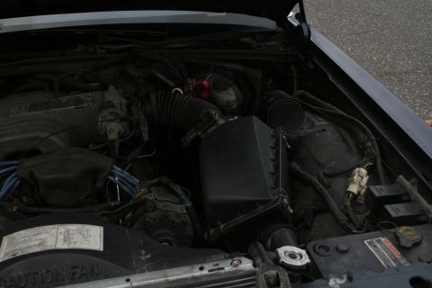 1989 Ford Crown Victoria LTD - The engine bay of a vehicle, showing various components and wiring.