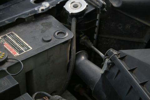 1989 Ford Crown Victoria LTD - Engine bay details showing a Motorcraft coolant reservoir and part of the air intake system.